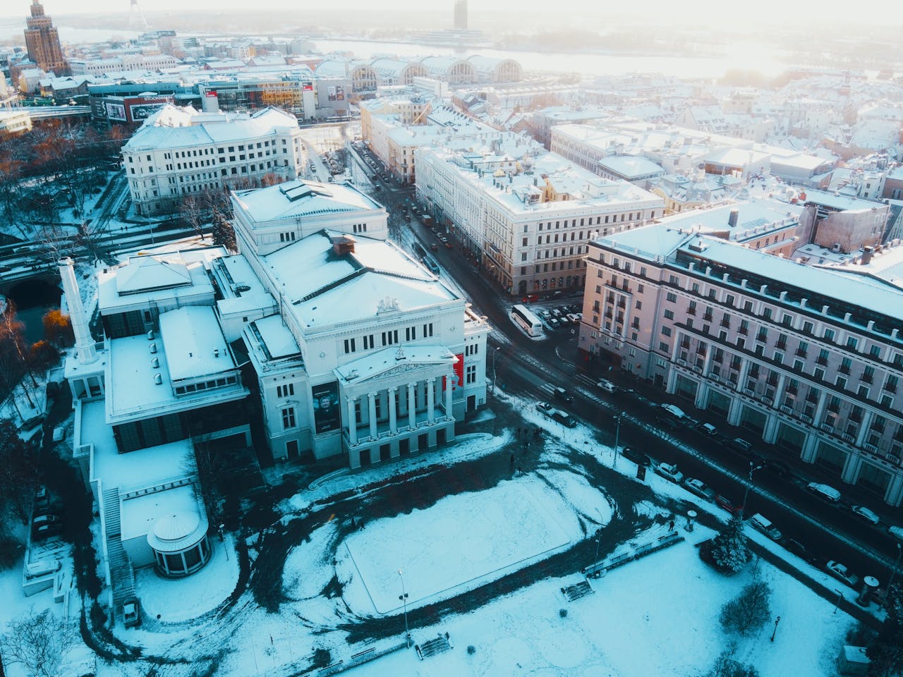 Captivating aerial view of Riga, Latvia blanketed in snow during winter, showcasing urban architecture.